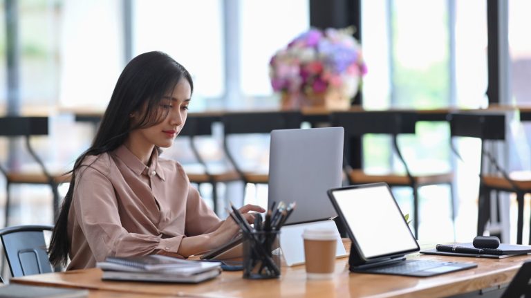 Young businesswoman concentrate working on computer laptop at office desk