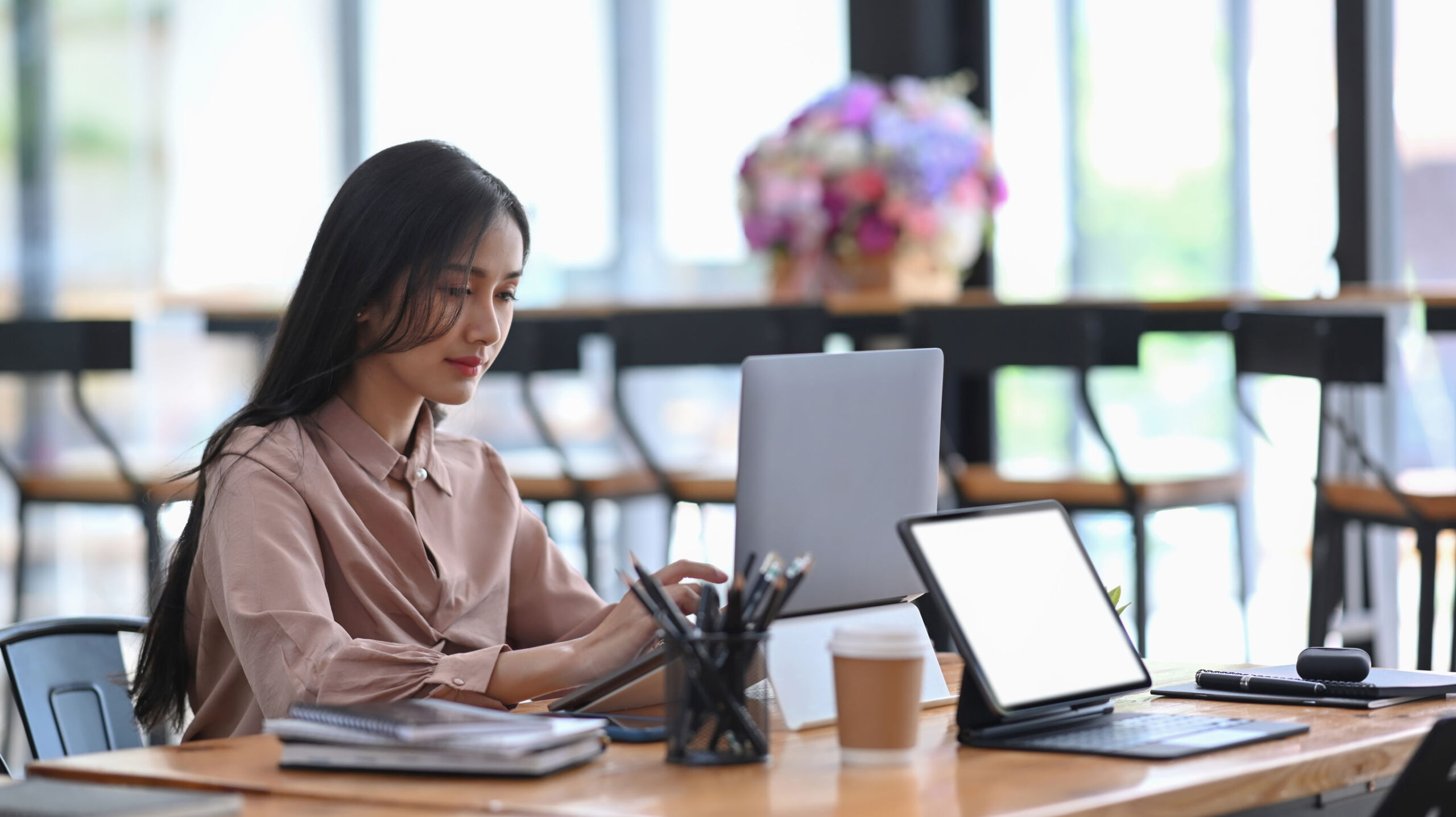 Young businesswoman concentrate working on computer laptop at office desk